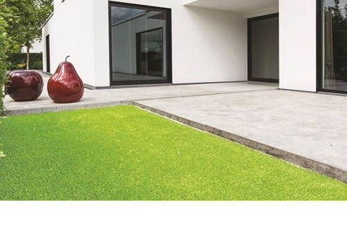 Artificial grass outside of white modern house. 