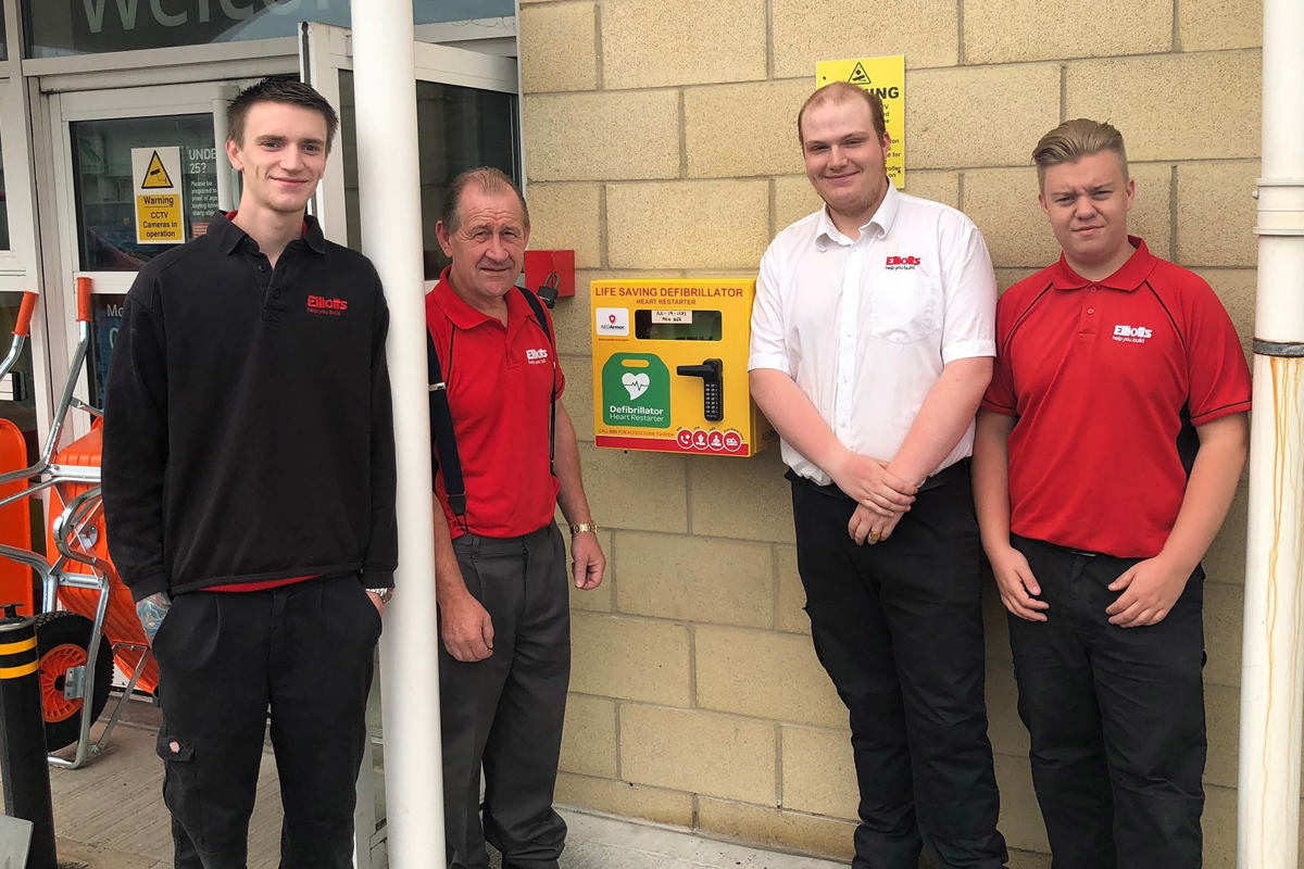 Elliotts employees with the 24-hour access defibrillator in Portsmouth